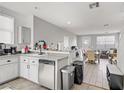 Open kitchen featuring tile floors, white cabinetry, modern appliances, and an adjoining dining area at 5324 Pendergrass St, North Las Vegas, NV 89081