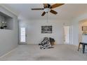 The living room is large and includes neutral paint, a ceiling fan, and an exit to the patio at 5855 Valley Dr # 2092, North Las Vegas, NV 89031