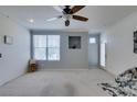 Bright living room with a ceiling fan, neutral-colored walls, large window, and plush carpeting throughout at 5855 Valley Dr # 2092, North Las Vegas, NV 89031