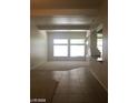 Bright living room with carpet, tile, large window for natural light, and staircase accent at 6245 Hawthorn Woods Ave, Las Vegas, NV 89130