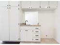 Bright, white kitchen area with modern fixtures and granite countertops at 6330 Spring Meadow Dr, Las Vegas, NV 89103