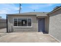 Home's front entrance with modern paint, a large window, and a charming blue door at 636 Burton St, Henderson, NV 89015