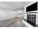 Inviting living room with fireplace, wood-look floors, and neutral paint at 6442 Ironbark Ln, Las Vegas, NV 89107