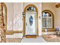 Close-up of a white front door with oval window, arched windows, and ADT security sign at 672 Hitchen Post Dr, Henderson, NV 89011