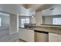 Bright kitchen featuring stainless steel dishwasher and granite countertops at 6800 E Lake Mead Blvd # 2072, Las Vegas, NV 89156
