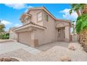 Charming two-story home featuring a tile roof, desert landscaping, and an attached two-car garage at 8379 Drop Camp St, Las Vegas, NV 89123