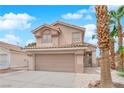 Charming two-story home featuring a tile roof, desert landscaping, and an attached two-car garage at 8379 Drop Camp St, Las Vegas, NV 89123