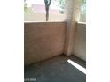 An empty private patio featuring stucco walls, ready for personalization and outdoor relaxation at 8769 Country View Ave, Las Vegas, NV 89129