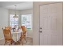 Bright breakfast nook featuring sunlight through windows and seating for four at 8800 Crescent Ridge Ln, Las Vegas, NV 89134