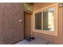 A cozy front porch is highlighted with a window for natural light at 8805 Jeffreys St # 1003, Las Vegas, NV 89123