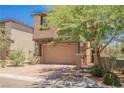 Beautiful two-story home featuring a two-car garage, meticulous landscaping, and mature shade trees at 920 Cirrus Cloud Ave, Las Vegas, NV 89138