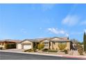 Inviting single-story home with a neutral color palette, three-car garage, and well-manicured front yard at 9240 Northfield Park Ct, Las Vegas, NV 89148