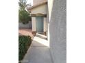 Front entrance showcasing a blue front door, columns, and gravel landscaping at 9617 Pine River Ln, Las Vegas, NV 89123