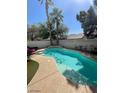 Refreshing private backyard pool surrounded by a lounge area with well-manicured trees, perfect for relaxation and outdoor enjoyment at 9801 Bradford Summit St, Las Vegas, NV 89183