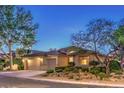 Attractive single-story home featuring desert landscaping, a three-car garage, and a tile roof at 10300 Wellside Hill Ave, Las Vegas, NV 89145