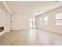 Bright and airy living room with sliding glass doors and modern recessed lighting at 105 Barkset Way, Henderson, NV 89011