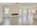 Bright and airy living space with tile flooring, a fireplace, recessed lighting, and plenty of natural light at 107 Barkset Way, Henderson, NV 89011