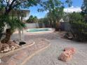 An inviting backyard with a refreshing pool and a meticulously designed patio area at 13 Desert Dawn Ln, Henderson, NV 89074
