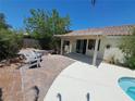 Backyard patio with lounge chairs and covered space, ideal for entertaining and outdoor relaxation at 13 Desert Dawn Ln, Henderson, NV 89074