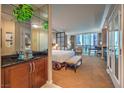 Well-appointed main bedroom with a glimpse of city views and an en-suite bathroom at 135 E Harmon Ave # 809, Las Vegas, NV 89109