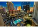 Aerial view showcases the sparkling pool, lush landscaping, and elegant outdoor lounging areas at 135 E Harmon Ave # 809, Las Vegas, NV 89109