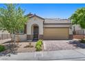 Charming single-Gathering home with a brick driveway, two-car garage, and well-maintained landscaping at 145 Langley Hill Ave, Henderson, NV 89002