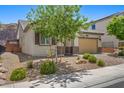 Single-Gathering home featuring desert landscaping, a two-car garage, and charming architectural details at 145 Langley Hill Ave, Henderson, NV 89002