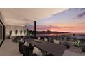 Outdoor dining area with mountain views at sunset at 1516 Pleasant Bay Ct, Henderson, NV 89011