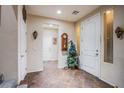 Spacious foyer with tile flooring, neutral walls, decorative accents, and a staircase at 1557 Blue Sierra Ct, Henderson, NV 89074