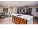 Open concept kitchen features a quartz island with sink, stainless appliances, and an eat-in dining area next to a living area at 1557 Blue Sierra Ct, Henderson, NV 89074
