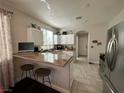 The kitchen has granite countertops, a breakfast bar, and stainless steel appliances at 1812 Warrenville St, Las Vegas, NV 89117