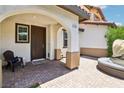 Charming front porch with brick flooring, comfortable seating, and a welcoming entrance at 1922 Via Delle Arti, Henderson, NV 89044