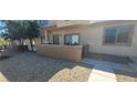 Apartment exterior showing front door, small patio with block wall, and desert landscaping at 2050 N Los Feliz St # 170, Las Vegas, NV 89156