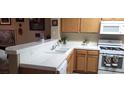 Kitchen with tile countertops and white appliances at 2050 N Los Feliz St # 170, Las Vegas, NV 89156