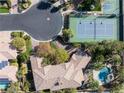 Aerial view of a house with a large backyard, pool, tennis court, and meticulously landscaped surroundings at 2285 Villefort Ct, Las Vegas, NV 89117