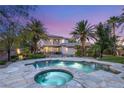 Beautiful backyard featuring a sparkling pool, relaxing spa, and well-manicured tropical landscaping for an inviting outdoor space at 2285 Villefort Ct, Las Vegas, NV 89117