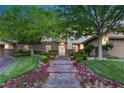 Charming home exterior with stone accents, manicured lawn, colorful flowers, and a welcoming entrance at 2285 Villefort Ct, Las Vegas, NV 89117
