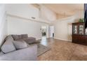 Bright living room featuring tile floors, a comfortable sectional sofa, and neutral walls, ready for relaxation and entertaining at 309 Clifton Heights Dr, Las Vegas, NV 89145