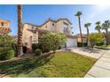 Charming two-story home featuring a three-car garage, stone accents, and desert landscaping at 323 Harpers Ferry Ave, Las Vegas, NV 89148