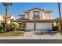 Charming two-story home featuring a three-car garage, stone accents, and lush front lawn at 323 Harpers Ferry Ave, Las Vegas, NV 89148