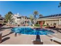 Inviting community pool with lounge chairs and well-maintained landscaping under a clear blue sky at 3425 E Russell Rd # 265, Las Vegas, NV 89120
