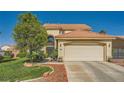 Well-maintained home with a two-car garage, manicured lawn, and desert landscaping at 3624 Snowy Pines St, Las Vegas, NV 89147
