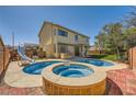 Outdoor oasis featuring a custom pool, spa, slide, and patio area at 3624 Snowy Pines St, Las Vegas, NV 89147