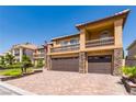 Two-story home with a dual garage, and balconies with black metal railings at 3738 Amber Lantern Cir, Las Vegas, NV 89147