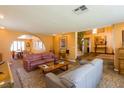 Spacious living room featuring couches, carpets, an archway and staircase at 3738 Amber Lantern Cir, Las Vegas, NV 89147