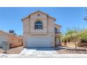 Two-story home with a two-car garage and manicured front yard landscaping at 3741 Cactus Wheel Ct, Las Vegas, NV 89129