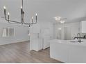 Open concept kitchen with stainless appliances, stone countertops, and modern lighting at 3741 Cactus Wheel Ct, Las Vegas, NV 89129