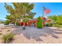Inviting home with desert landscaping and an American flag at 4045 N Chieftain St, Las Vegas, NV 89129