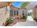 Charming courtyard featuring a fountain, mature plants, and direct access to the front entrance at 4636 Riva De Romanza St, Las Vegas, NV 89135