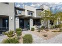 Stylish two-story home with modern gray exterior, well-manicured landscaping, and inviting front porch at 494 Mahogany Ridge St, Las Vegas, NV 89138